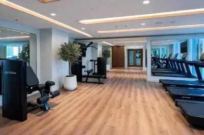 a gym with treadmills and elliptical machines at Luxury 3BR Marina View at Palace Beach Residence in Dubai