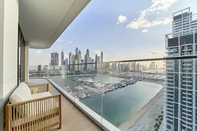 a balcony with a view of a harbor and a city at Luxury 3BR Marina View at Palace Beach Residence in Dubai