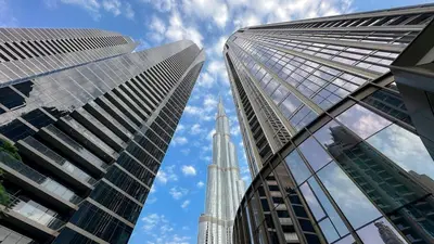 a view of the empire state building from between two buildings at Polo Bar DXB a High Floor 1BDR in Downtown Dubai in Dubai