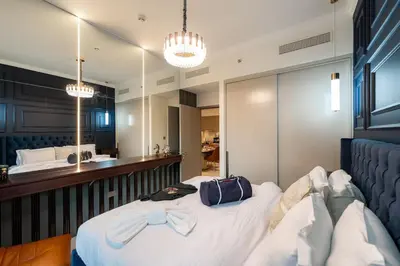 a bedroom with a bed with a bow tie on it at Polo Bar DXB a High Floor 1BDR in Downtown Dubai in Dubai