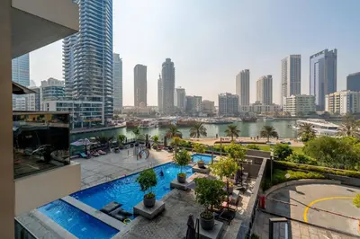 a view of a city from a building with a swimming pool at New! Serene 2BR with Balcony & Pool in Sparkle Tower in Dubai