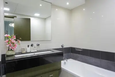 a bathroom with a tub and a sink and a mirror at Silk Valley - Luxury 2BR in Downtown near Burj Khalifa & Dubai Mall in Dubai
