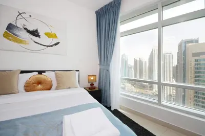 a bedroom with a bed and a large window at Silk Valley - Luxury 2BR in Downtown near Burj Khalifa & Dubai Mall in Dubai