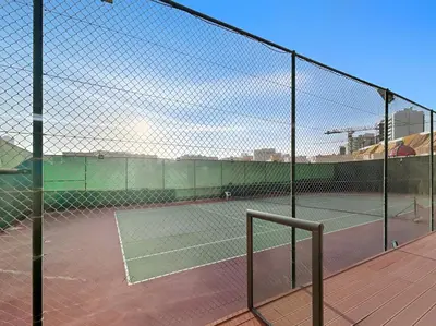 a tennis court with two tennis courts at New! Serene Studio with Balcony and Pool Crystal Res in Dubai