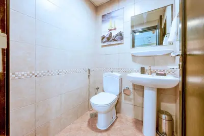 a bathroom with a toilet and a sink at Royal oceanic Dubai marina in Dubai