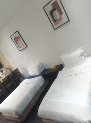 two beds sitting next to each other in a room at Royal oceanic Dubai marina in Dubai