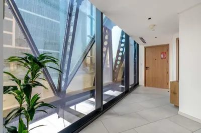 a hallway with large windows in a building at New! Spacious 2BR with Burj Views in Marquise Square in Dubai