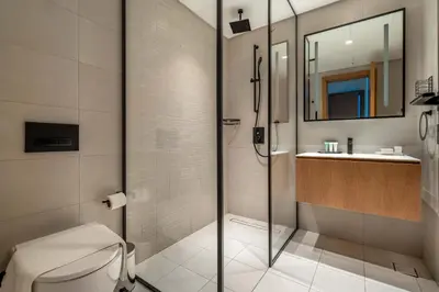 a bathroom with a shower and a toilet and a sink at New! Spacious 2BR with Burj Views in Marquise Square in Dubai