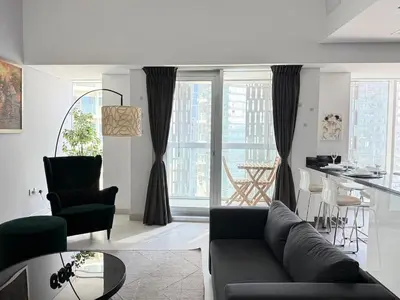 a living room with a couch and a table at Cayan Tower, Dubai Marina in Dubai