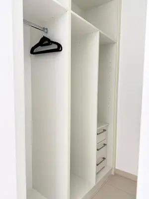 a white walk in closet with a mirror at Cayan Tower, Dubai Marina in Dubai