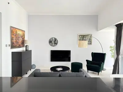 a white living room with a couch and chairs at Cayan Tower, Dubai Marina in Dubai