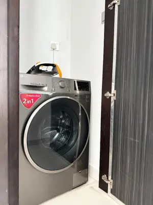 a washing machine in a room next to a door at Cayan Tower, Dubai Marina in Dubai