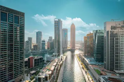 a river in the middle of a city with tall buildings at Brand New Luxury Waterfront 2bd Beautiful Canal View in Dubai