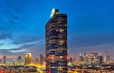 a tall building with a city in the background at Damac Maison Mall Street! Upgraded 3 Bedroom with Burj and DIFC views! Nearest to Dubai Mall in Dubai