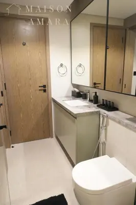 a bathroom with a toilet and a sink at Luxury 1BR Apartment - DAMAC Hills - Infinity Pool in Dubai