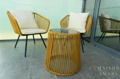 a rattan table and chairs in a room at Luxury 1BR Apartment - DAMAC Hills - Infinity Pool in Dubai