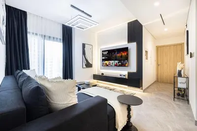 a living room with a couch and a tv at Luxury 3 Bedroom Apartment, 8 mins from Dubai Mall, Sleeps 6 people in Dubai