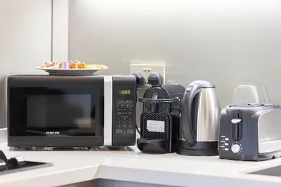 a kitchen counter with a microwave and other appliances at Luxury 3 Bedroom Apartment, 8 mins from Dubai Mall, Sleeps 6 people in Dubai