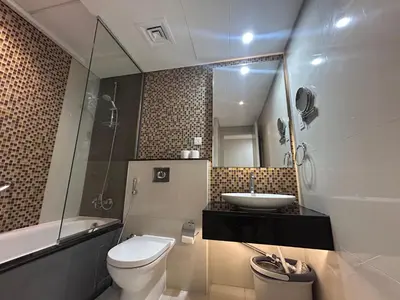 a bathroom with a sink and a toilet and a mirror at Sunrise Homes A Beautiful Studio in Downtown in Dubai