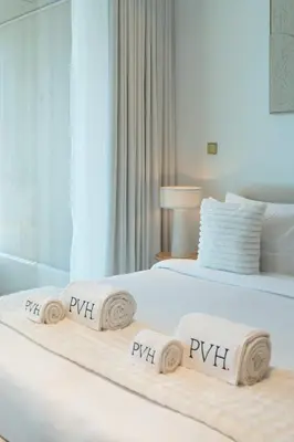 a hotel room with two beds with towels on them at PVH - Ellington Beach House - Luxurious 1BR with Private Beach Access in Dubai