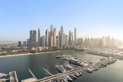 an aerial view of a city with a harbor with boats at Luxe 2BR with Full Marina Views & Beach Access in Dubai