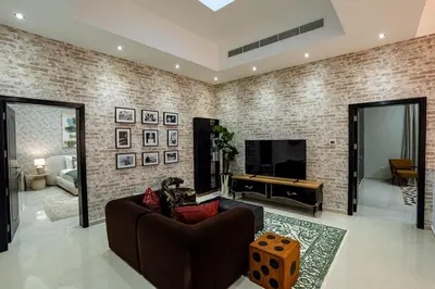 a living room with a couch and a pool table at Iconic Villa in Dubai