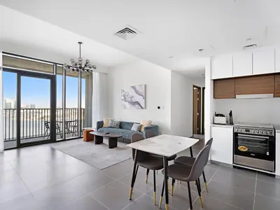a kitchen and living room with a table and chairs at Creek Harbour Gem Stylish 2BR with Stunning Views-17 in Dubai