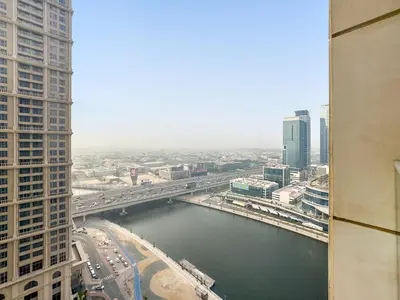 a view of a river in a city with buildings at Charming City View w 1BDR Apartment In Noura Tower in Dubai
