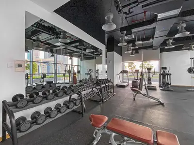 a gym with several rows of machines and chairs at Silkhaus Entrepreneur Work & Stay Studio in DIFC in Dubai