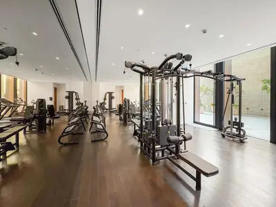 a gym with a bunch of treadmills and machines at Spacious 2BR in Business Bay with Canal View in Dubai