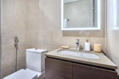 a bathroom with a toilet and a sink at STAY BY LATINEM Luxury 1BR Holiday Home CV A 907 near Dubai Mall in Dubai