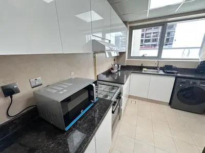 a kitchen with a microwave on a counter with a sink at Prime Apartments Near WTC and Sheikh Zayed RD in Dubai