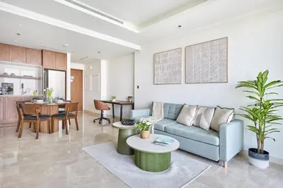 a living room with a couch and a table at Frank Porter - Palace Beach Residence in Dubai