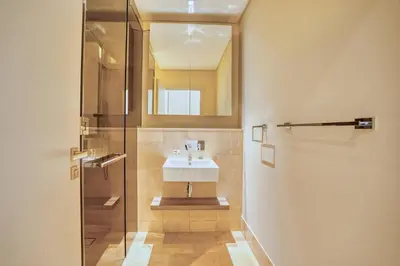 a bathroom with a sink and a mirror at PVH - The 8 - Opulent 3BR with Sea View and Private Beach Access in Dubai