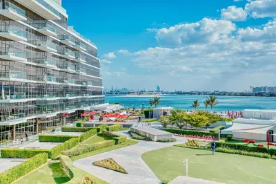 a view of a large apartment building and the water at PVH - The 8 - Opulent 3BR with Sea View and Private Beach Access in Dubai