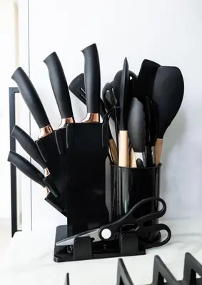 a container of cooking utensils on a counter at Sleeps 4 I Circle Mall I Epic Pool in Dubai