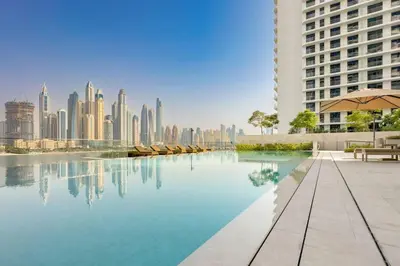 a pool with a city skyline in the background at Dubai Harbour Marina View with Beach Access in Dubai