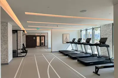 a gym with a row of treadmills and machines at Dubai Harbour Marina View with Beach Access in Dubai