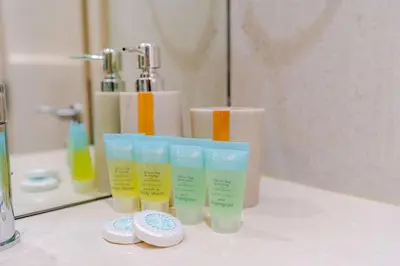 a group of four bottles of moisturizers on a counter in a bathroom at Sunny Studio - Dubai Marina - Close Beach in Dubai