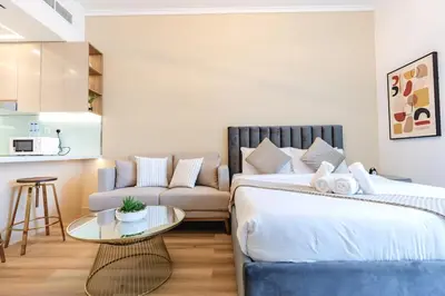 a bedroom with a bed and a couch and a table at Sunny Studio - Dubai Marina - Close Beach in Dubai