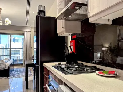 a kitchen with a stove and a counter top at Elite Downtown Residence, Downtown Dubai - Onelink in Dubai