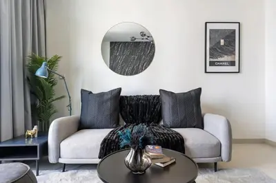 a living room with a couch and a table at 3Min to Dubai mall and Burj Khalifa, Luxury 1B and Amenities in Dubai