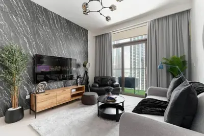 a living room with a couch and a flat screen tv at 3Min to Dubai mall and Burj Khalifa, Luxury 1B and Amenities in Dubai
