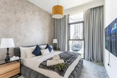 a bedroom with a large bed and a large window at 3Min to Dubai mall and Burj Khalifa, Luxury 1B and Amenities in Dubai
