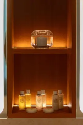 a shelf with four candles and a bowl on it at Exclusive 2BR Residence on Palm Jumeirah - Beach Access in Dubai
