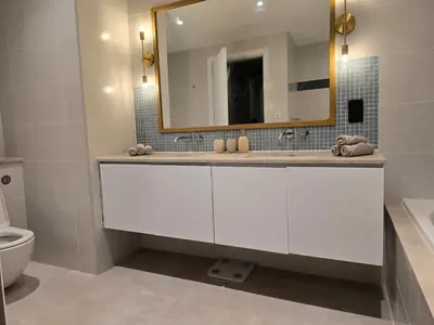 a white bathroom with a sink and a mirror at Top Floor Penthouse In Oceana With Panoramic Views in Dubai