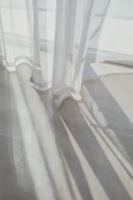 a window with white curtains on a floor at Top Floor Penthouse In Oceana With Panoramic Views in Dubai