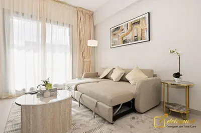 a living room with a couch and a table at Oversized 1BR Apartment Near Dubai Hills Mall in Dubai