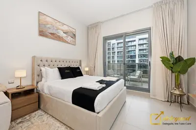 a bedroom with a large bed and a window at Elite Studio in Dubai Hills Near Dubai Hills Mall in Dubai