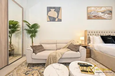 a living room with a couch and a bed at Elite Studio in Dubai Hills Near Dubai Hills Mall in Dubai